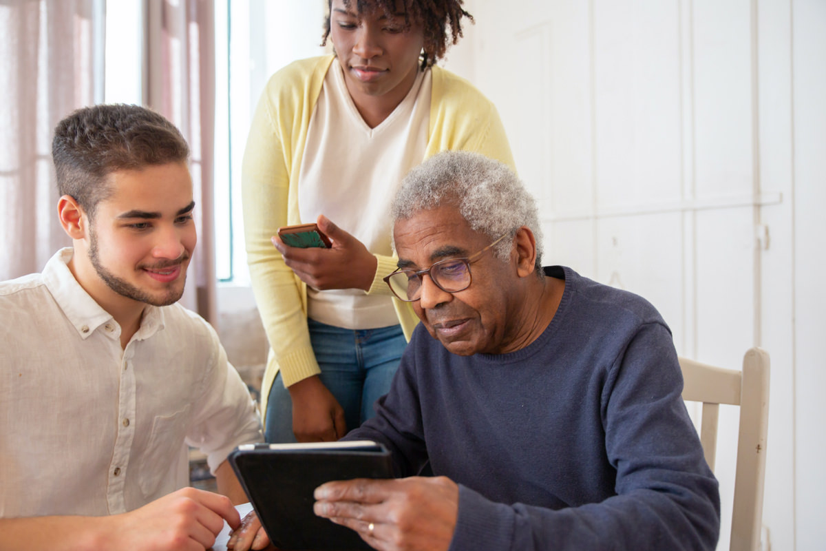 Two Parents with Teen Son Looking at a Tablet Device